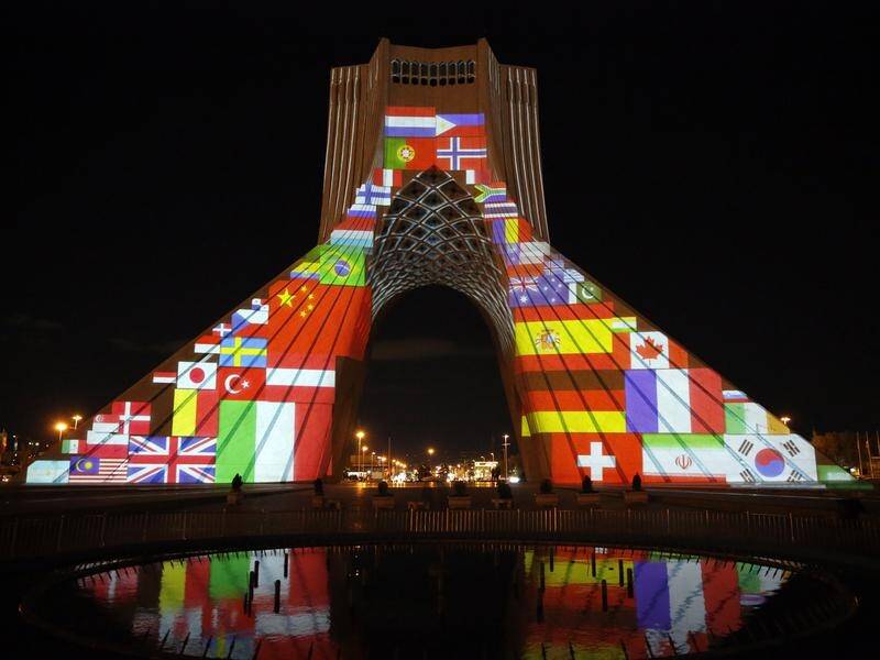 Iran's Azadi tower lit up with flags and sympathy messages as the world virus death toll hit 40,000.