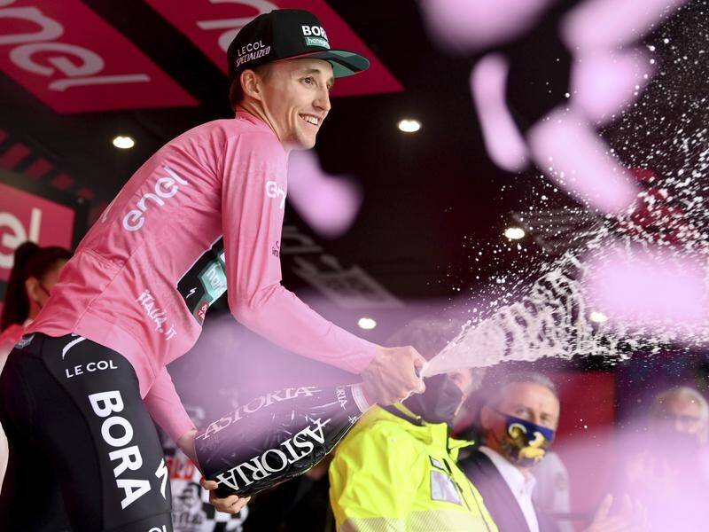 Champagne-spraying Jai Hindley is only the second Aussie to win one of the Grand Tours.