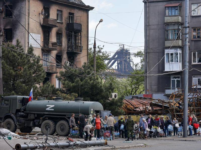 Civilians gather in Mariupol's streets to get essentials such as food, water and clothing.