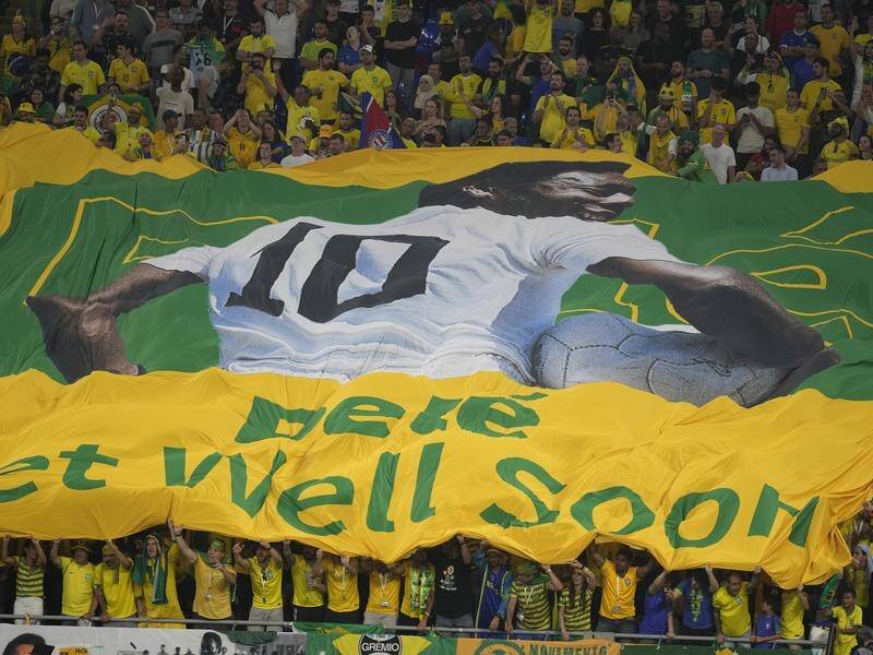 Brazilian fans at the World Cup hold a banner showing support for soccer legend Pele. (AP PHOTO)