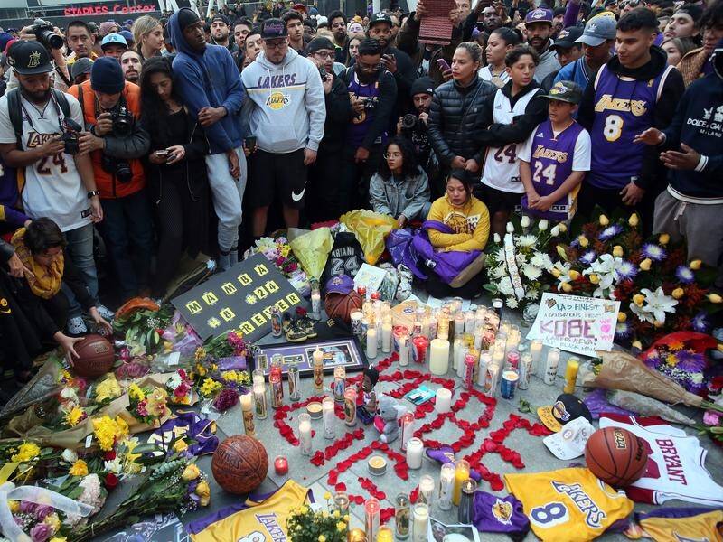 Fans place flowers, candles and memorabilia during a vigil for Los Angeles Lakers guard Kobe Bryant.