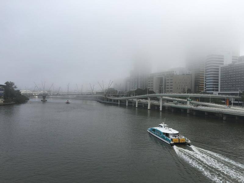 Flights in and out of Brisbane airport are being delayed due to a thick fog covering the city.