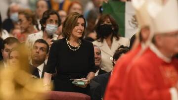 Speaker of the House Nancy Pelosi looks at Pope Francis as he celebrates a Mass at St. Peter's.