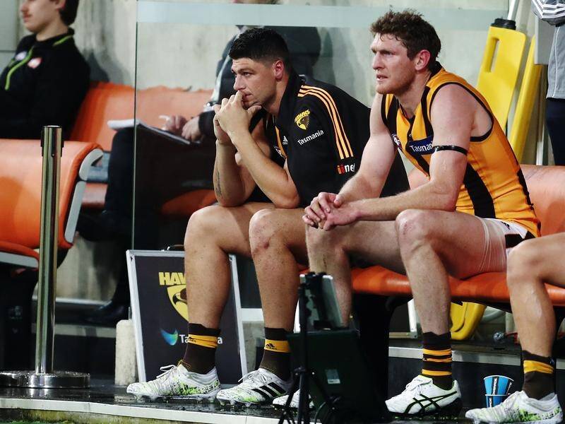 A hamstring injury will keep Hawthorn's Jonathon Patton (l) on the sidelines for at least a month.