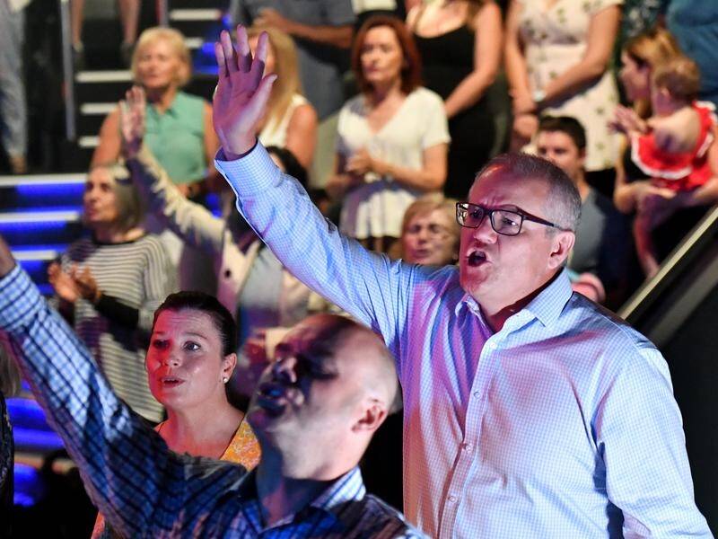 Scott Morrison and wife Jenny sing during an Easter Sunday service at their church in Sydney.