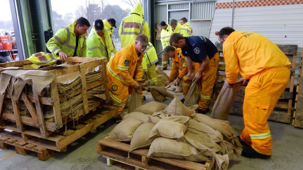 Local emergency services personnel prepare sandbags to distribute across the Highlands. Picture: Leonie Knapman