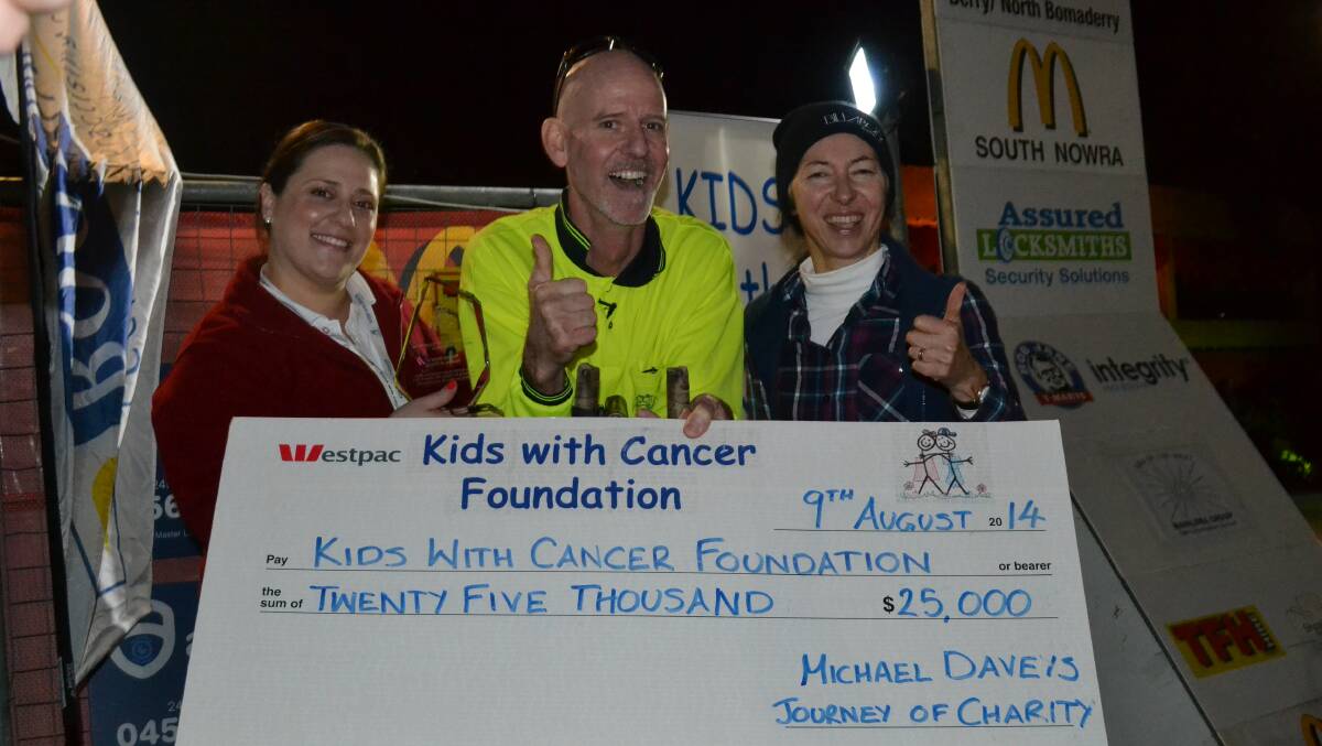 TOP EFFORT: Charity bike rider Dr Mick Davey and his wife Barbie present their $25,000 cheque to Kids With Cancer Foundation representative Vanessa Senior (left) at the inaugural Sleep Out Shoalhaven event.