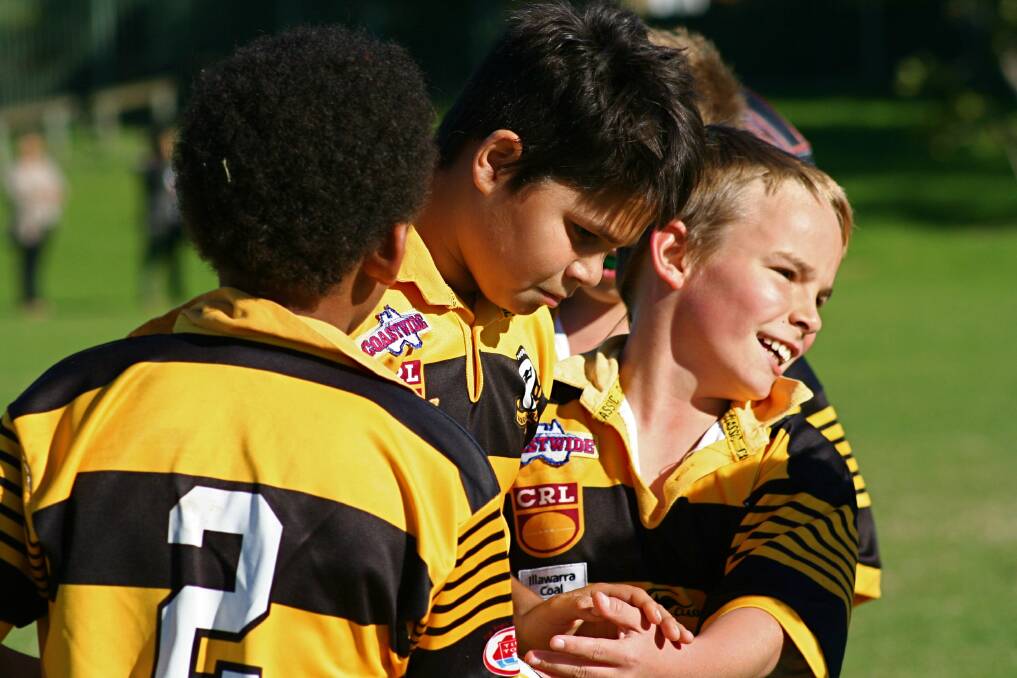 GREAT WORK: Nowra Warriors u10 teammates Rylie Oliver and Jarrad Omoeboh congratulate Jarrah McLeod for scoring the first try in their team’s round 10 match against Warilla.