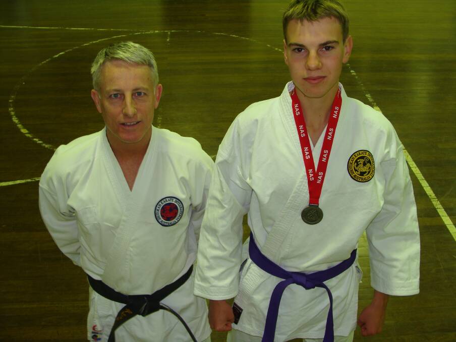 KARATE CHOP: Nowra Karate instructor David Rush and student Owen Bourke show off their medals won at the NSW National All Styles martial arts tournament. 