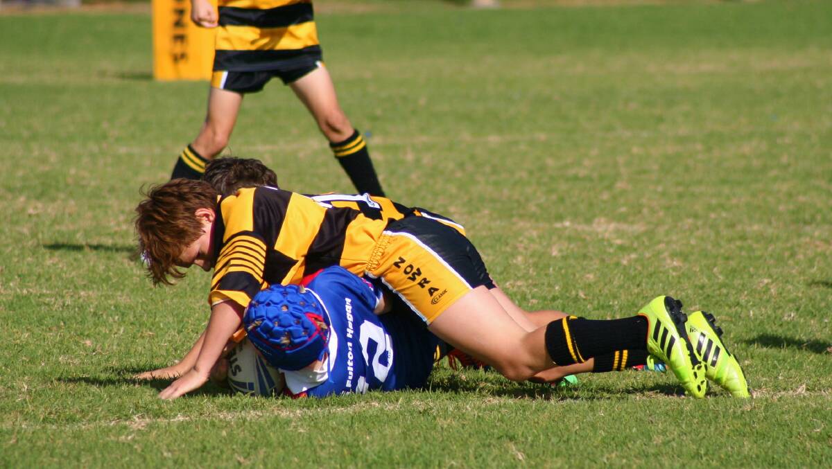 UNPASSABLE: The Nowra Warriors u10’s show some tough defence, stopping any possible offloads from the opposition. 