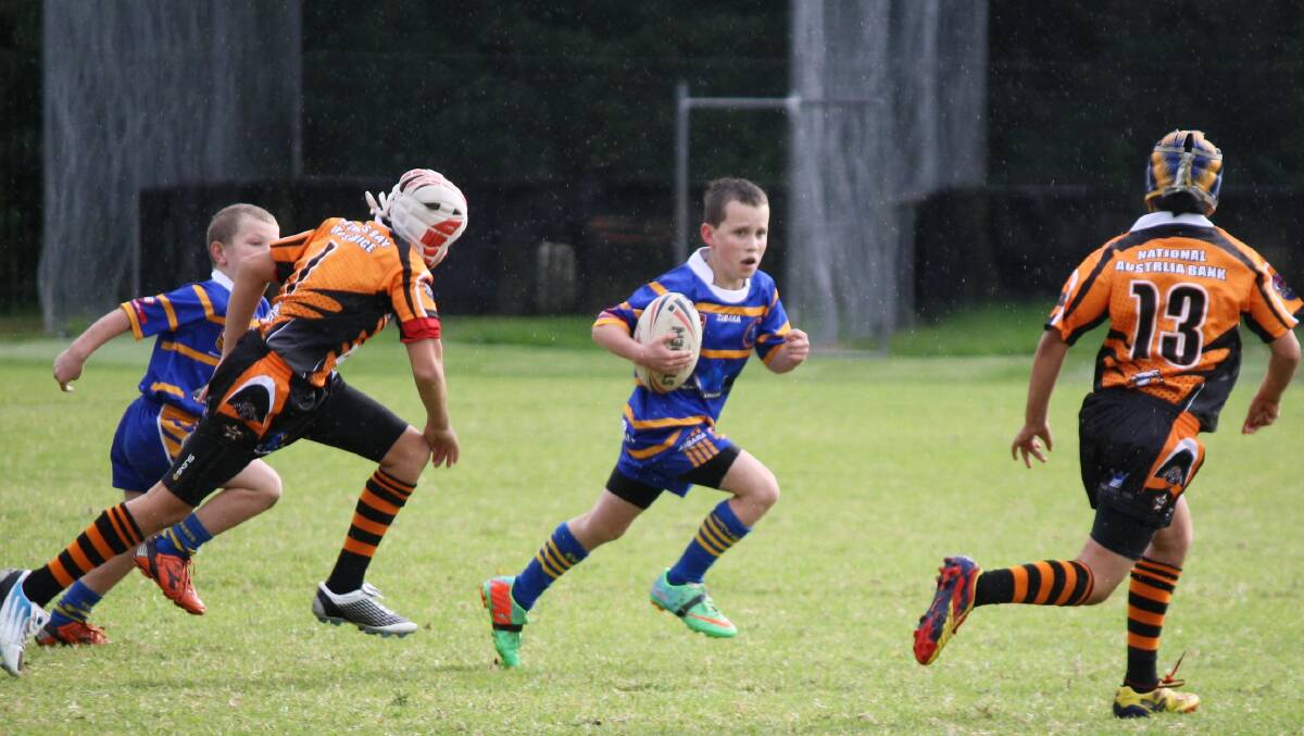 TOUGH AS NAILS: Bomaderry Swamp Rats under 10 player Calib McGillick on his way to scoring a try in the rain during last Saturday's game. 