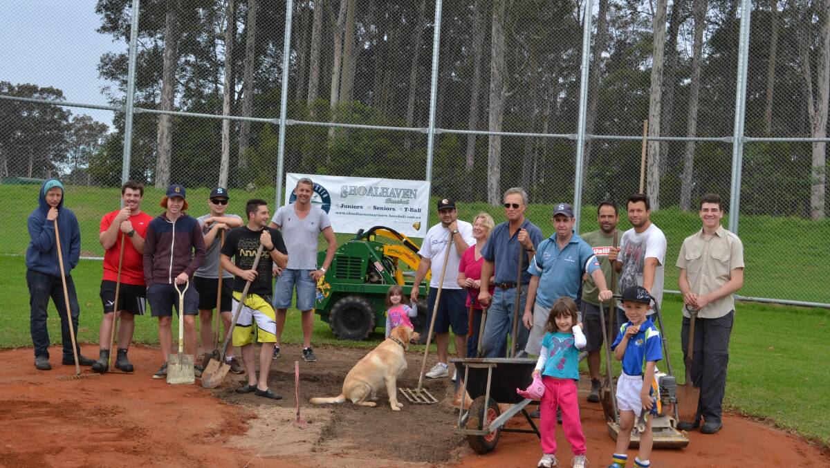A team of locals and members of the Shoalhaven Mariners baseball team gather on Saturday to help build a new local baseball diamond.