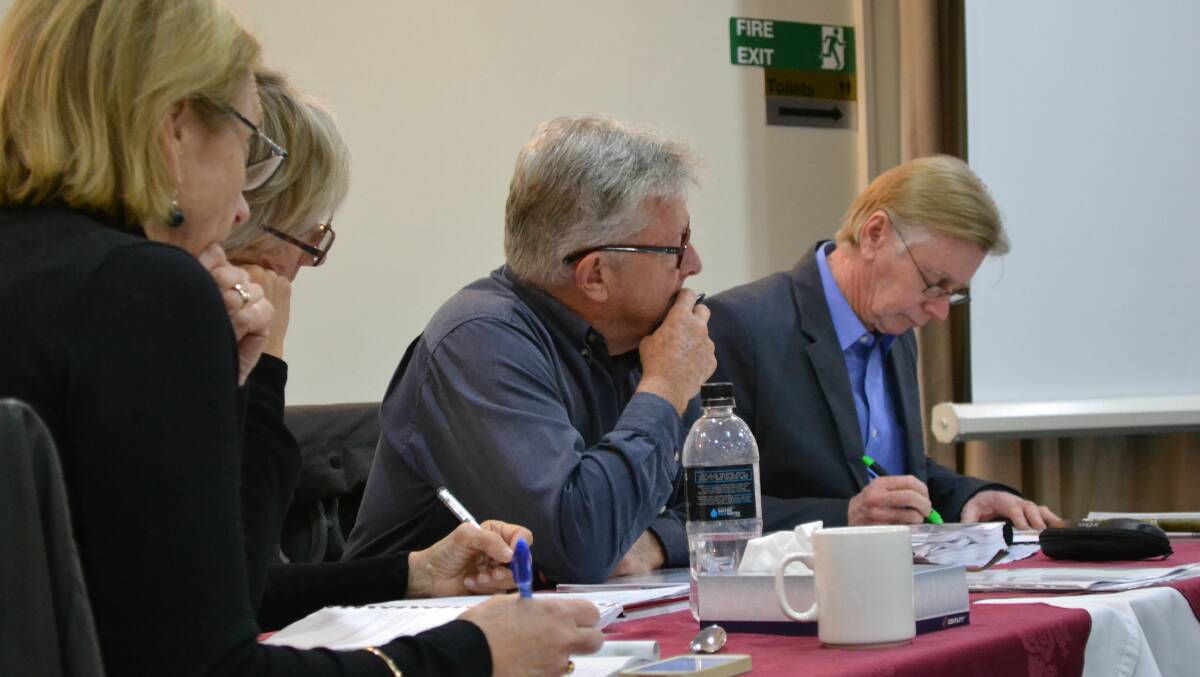 Members of the Planning Assessment Commission, planner Nicky Gibson, chairperson and environmental lawyer Donna Campbell, retired architect Richard Thorp and environmental scientist David Johnson listen to submissions at the public meeting.