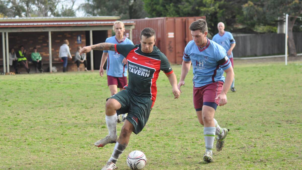 ON THE BALL: Illaroo’s Jamie Kennedy is marked by Alex Stokes from Shoalhaven Heads during Saturday’s clash, which Heads won 2-1. Photo: PATRICK FAHY  