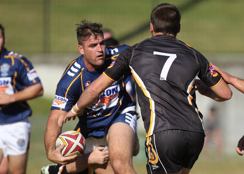 TIGHT FINISH: Warilla-Lake South lock Aaron Henry looks to offload for the Group 7 Bulls during their nail-biting 24-22 win against Group 6 at Centenary Field on Saturday. Photo: DAVID HALL   