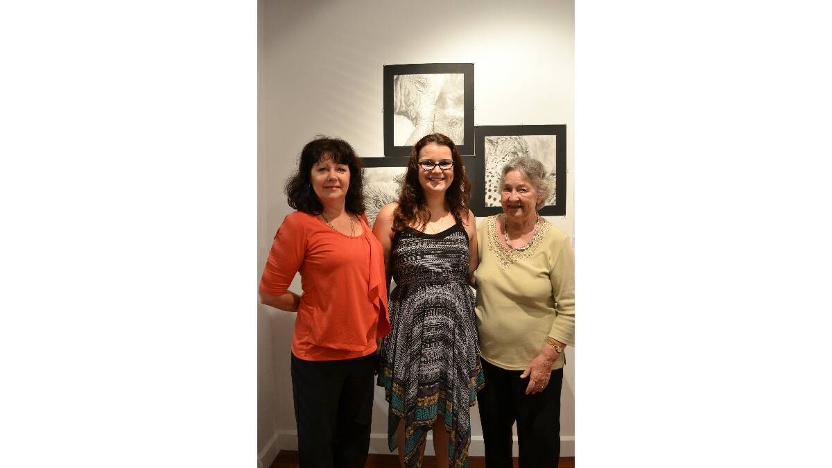 Susan Gould, artist Natarsha Bradstock and Helen Bradstock from Callala Bay admire the artwork Family Love at the opening of the Body Of Work: Wow! showcase at the Shoalhaven City Arts Centre on Saturday.