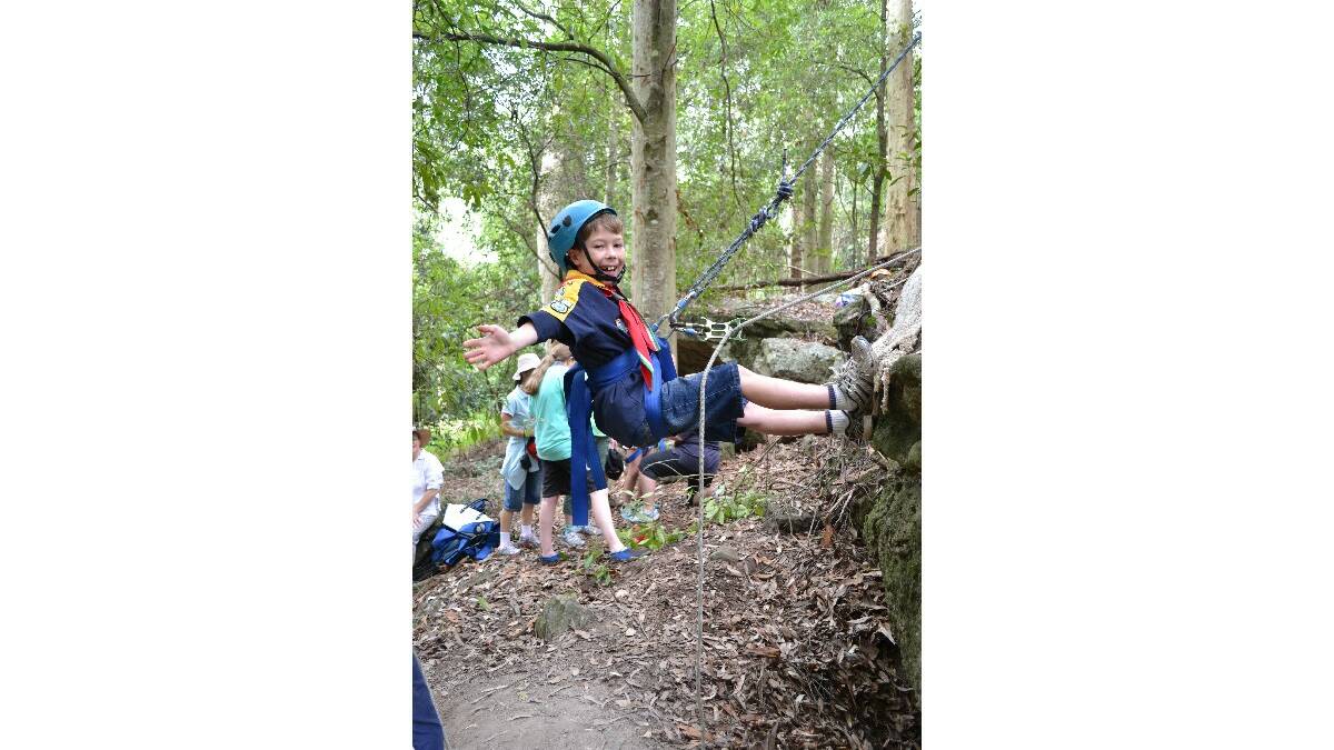 Ethan Carruthers from Figtree braves the abseiling at the Combined Camp of Guides and Scouts at Bangalee Scout Camp on Saturday.