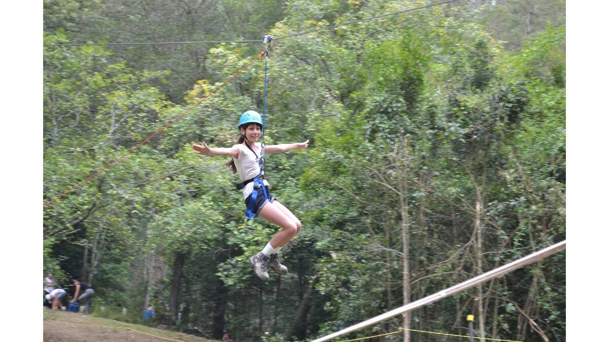 Ashley Wilson from Figtree has a great time on the flying fox at the Combined Camp of Guides and Scouts at Bangalee Scout Camp on Saturday.