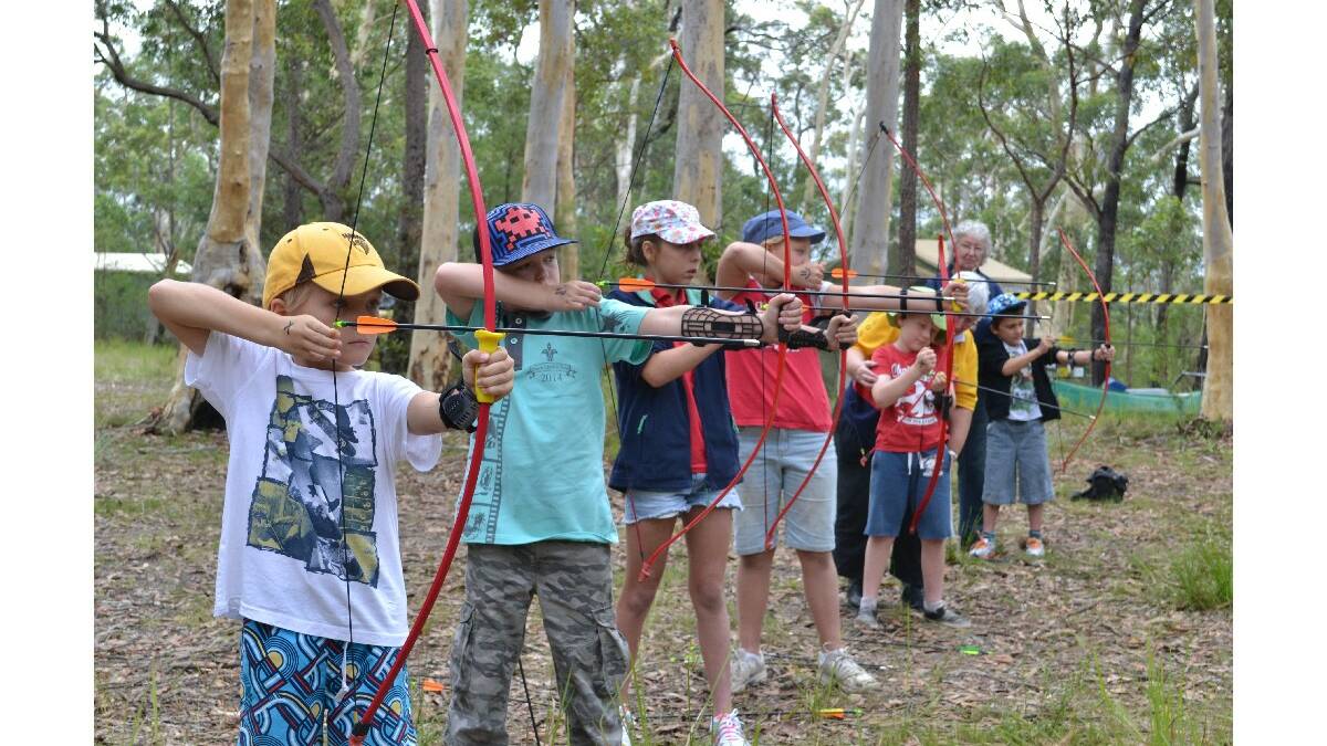 Tasman Koorey from Kiama, James and Emily Horvat from Sussex Inlet, Zeffani Koorey from Kiama, Jack Whitney from Dapto and Tana Waine from Gunning take a lesson in archery at the Combined Camp of Guides and Scouts at Bangalee Scout Camp on Saturday.