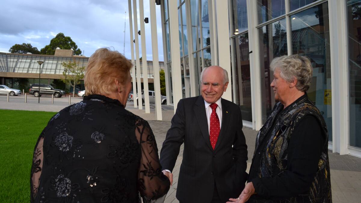 Member for Gilmore Ann Sudmalis and former member Joanna Gash greet former prime minister John Howard at Cr Gash's honorary dinner at the Shoalhaven Entertainment Centre on Thursday night.