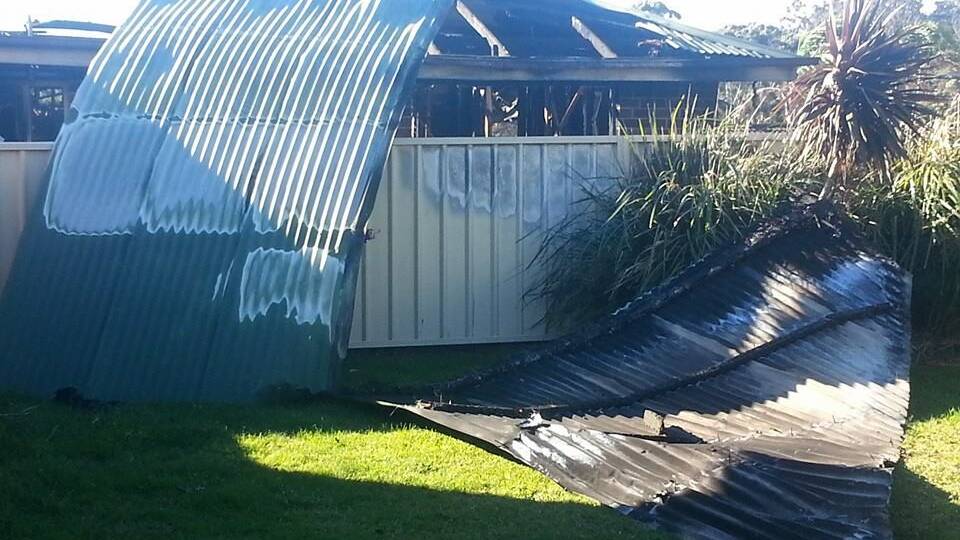 Donna Doyle in Village Drive, Ulladulla, has had SES crews in her backyard this afternoon clearing away material from a neighbours roof which was blown into her yard