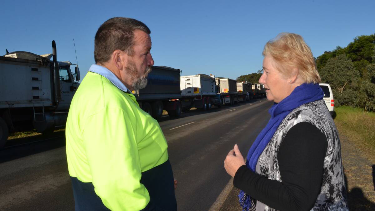 NOT HAPPY, ANN: Mark Nelson from Coordinated Logistics speaks to Gilmore MP Ann Sudmalis about subcontractors being owned millions of dollars for the new maintenance and training facilities being constructed at HMAS Albatross at Monday morning’s peaceful protest off Braidwood Road.