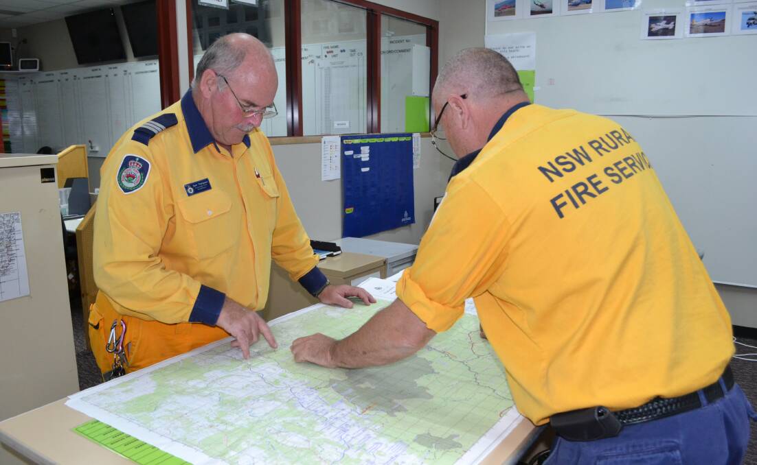 ALARMING: NSW Rural Fire Service Greenwell Point captain Sam Thompson and RFS Shoalhaven District inspector Chris Palmer inspect the Shoalhaven incident map after a busy long weekend which involved 25 separate incidents.