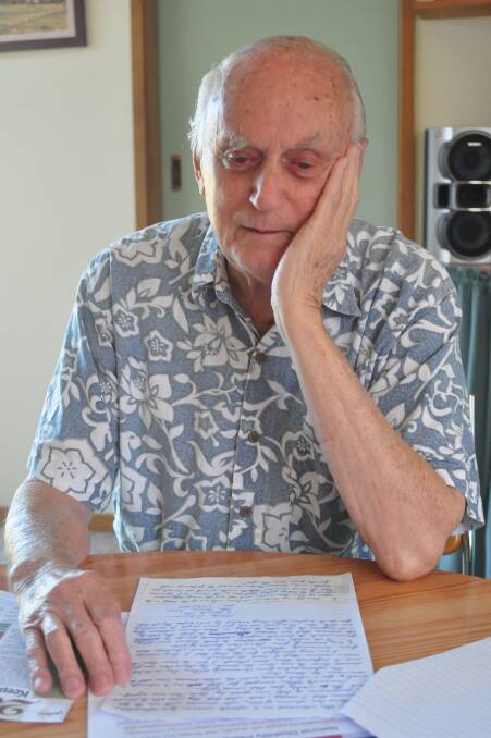 LONG WAIT: North Nowra resident Bob Stevenson goes over a letter his wife Shirley dictated pleading for more funding in the aged care sector.