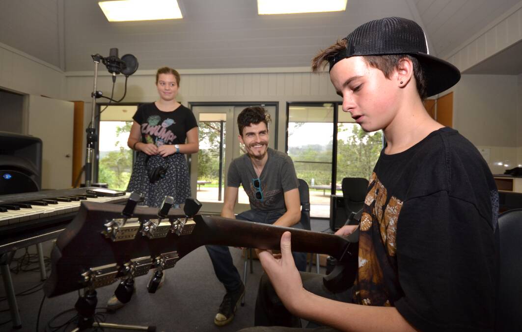 TUNED IN: Wollongong High School of the Performing Arts year 11 student Sophia Simoes Da Silvam, and year 7 student Riley Horton work with Rai Thistlethwayte from Thirsty Merc during a three-day camp at Waterslea Conference Centre in the Shoalhaven. Photo: ADAM WRIGHT