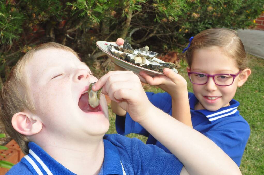 TASTY: Greenwell Point Public School year 1 students, Sam Riepsamen and Megan Mank, whose parents are oyster farmers, are excited by the inaugural Greenwell Point Fish and Oyster Festival.