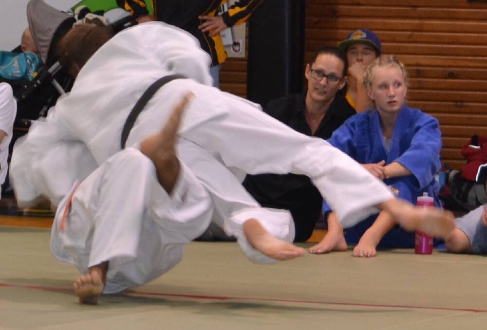 IT’S ON: Danny Fagan flips a competitor in the open men’s division at the Shoalhaven Open Judo Championships.