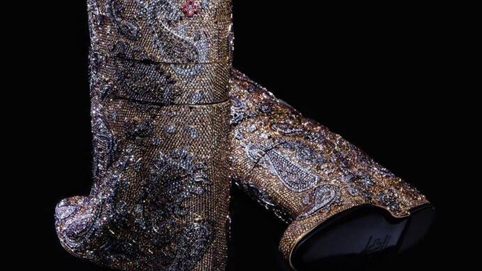 EDEN: Local jeweller Georgie Staley tried on these boot encrusted with 38,883 diamonds and valued at $3.188 million (US).  She was loathe to give them back! 