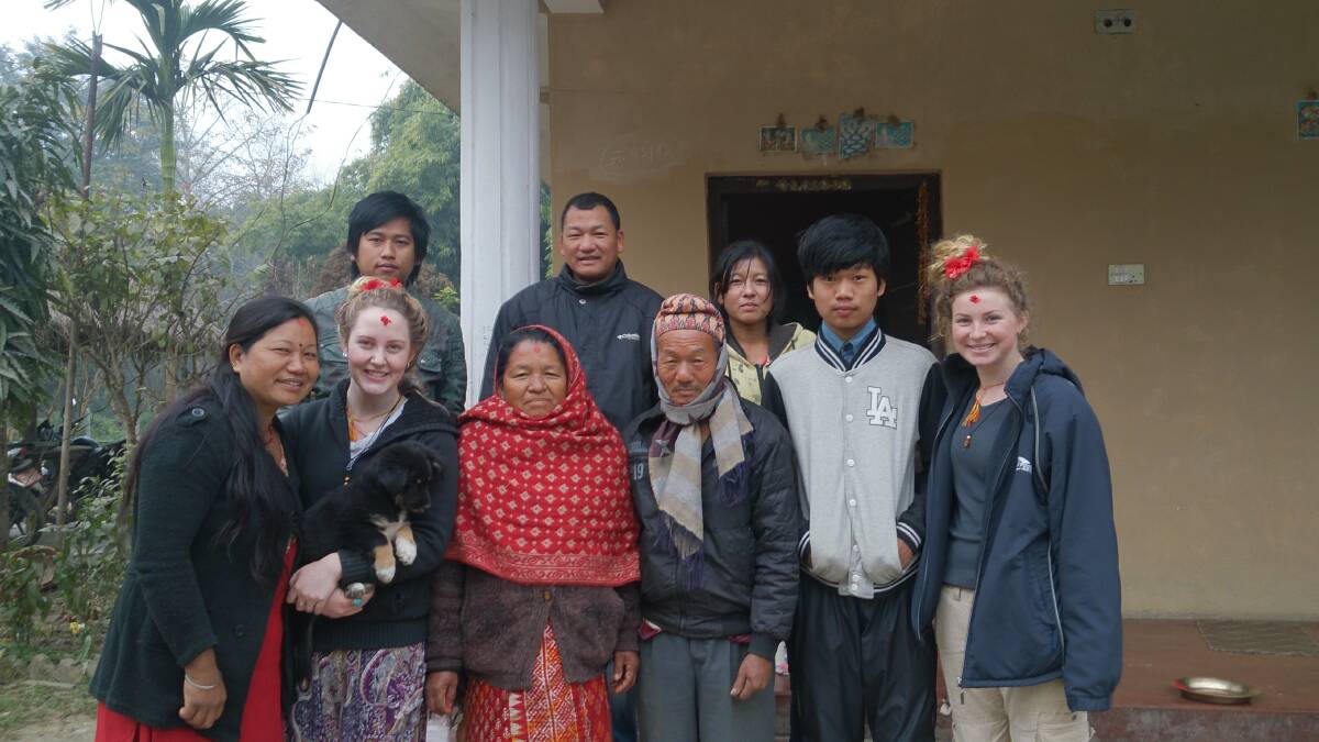ULLADULLA: Ulladulla High School students Sarah McQuarrie and Georgia Murdoch pose with the family they stayed with while volunteering in Nepal over the summer school holidays. 