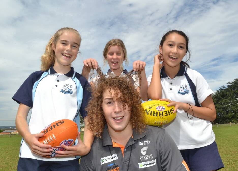 Nowra High School students Brooke Deane, Brianne Harris, Neysha Forster with NSW/AFL rep Mat Farrow at Artie Smith Oval during the Girls Get Active Schools Day.