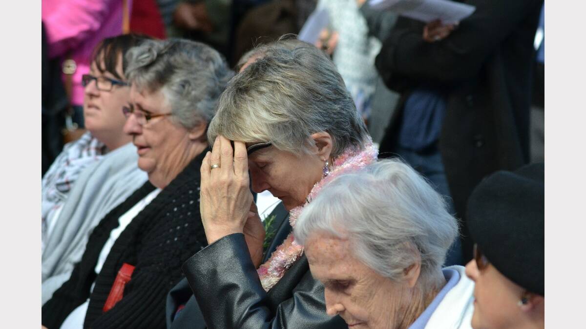 People in the crowd are moved by the service.