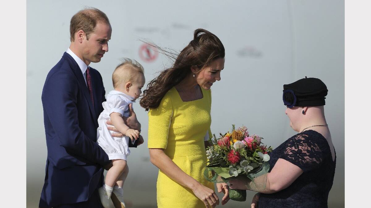 Her Royal Highness, Catherine Duchess of Cambridge receives flowers from Joscelyn Sweeney, with His Royal Highness Prince William, Duke of Cambridge holding Prince George on arriving at Sydney Airport. Photo: KATE GERAGHTY