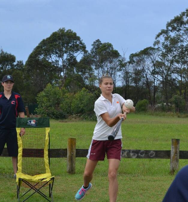 Vincentia High School student Rebecca Miles almost hits a home run during baseball at the Girls Get Active Schools Day in Bomaderry.