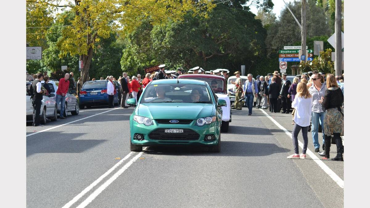 Cars and people line up ready for the 2014 Berry Anzac Day march along Queen Street.