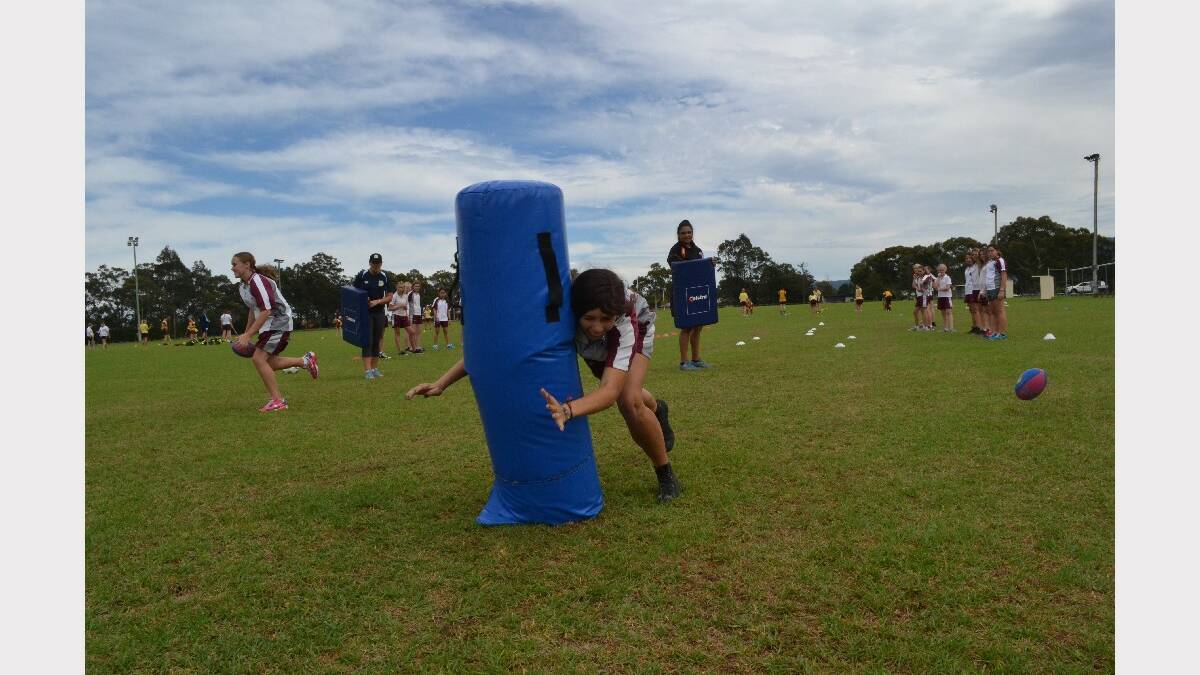 Vincentia High School student Scarlett Lea hits the tackle bag during Girls Get Active Schools Day in Bomaderry.