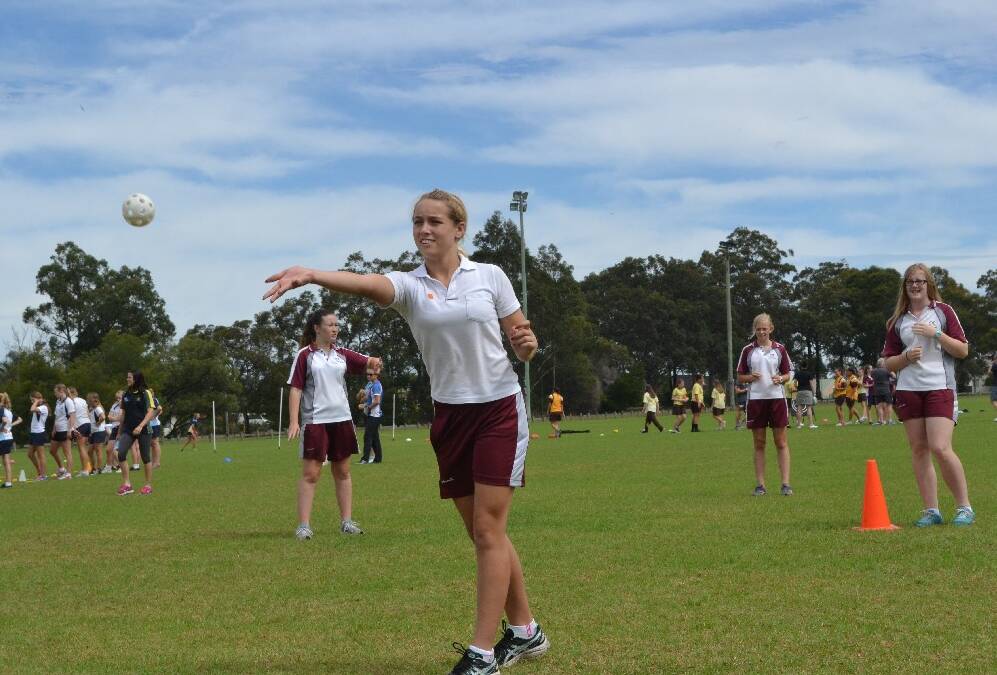 Vincentia High School year 9 student Teah McInally pitches the ball during the Girls Get Active Schools Day in Bomaderry.