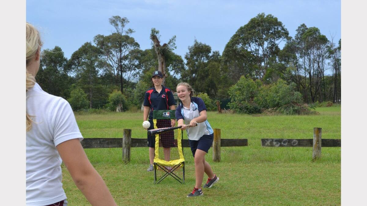 Nowra High School year 8 student Caitlin Davis smashes the ball during baseball at the Girls Get Active Schools Day in Bomaderry.