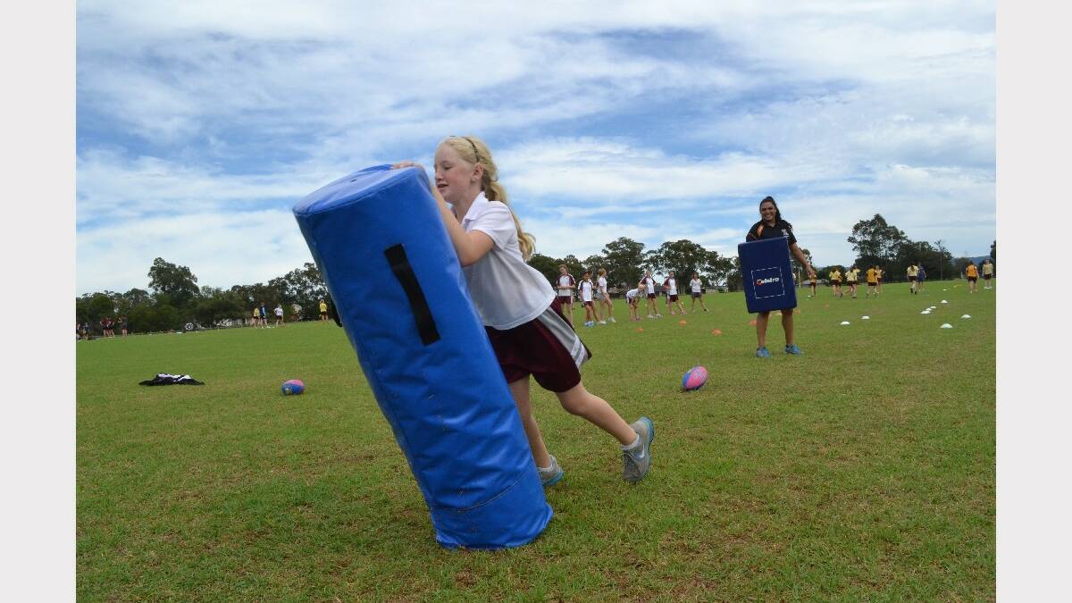 
Sampling league Katherine Sinnott from Vincentia High School takes down the tackle bag during baseball at the Girls Get Active Schools Day in Bomaderry.