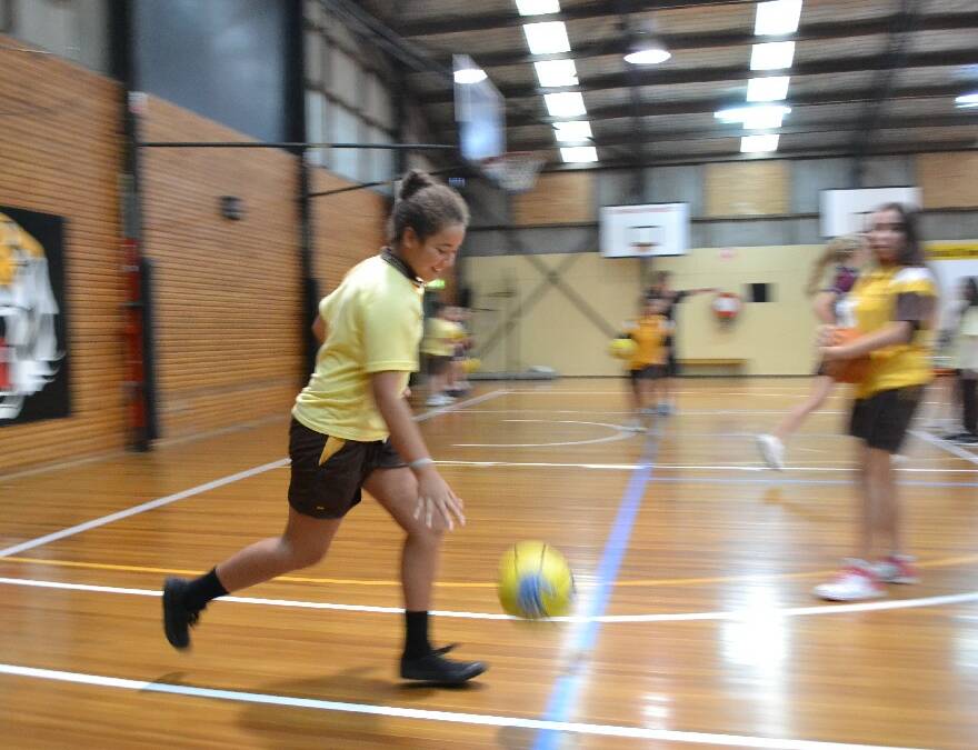 Shoalhaven High School year 7 student Ema Anitoni heads down the court move during the Girls Get Active Schools Day.