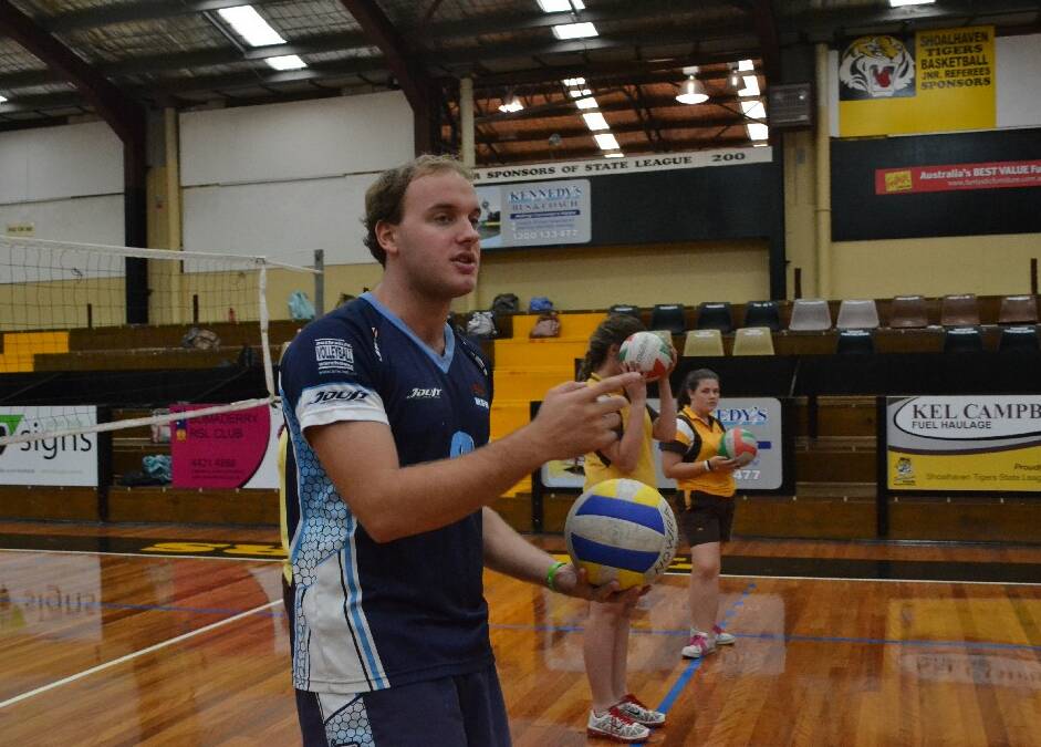 Volleyball representative Nicholas Thorpe shows some Shoalhaven High School girls how to play volley ball during the Girls Get Active Schools Day.