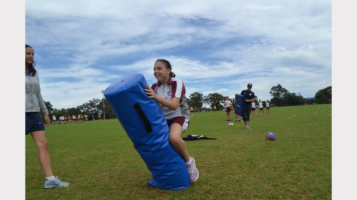 Vincentia High School student Skye-Anne Thompson hits the tackle bag during Girls Get Active Schools Day in Bomaderry.