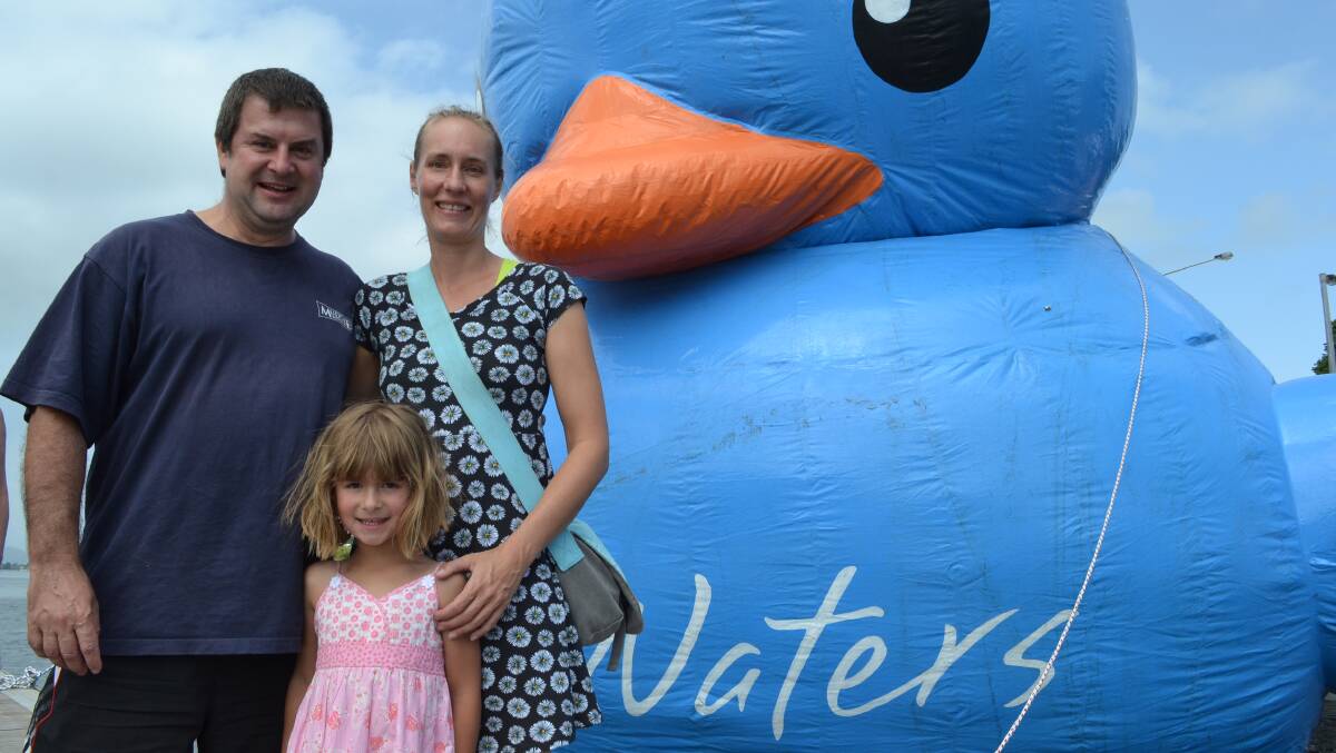 FAMILY EVENT: Chris Rowe, Daniela Heubusch and Annika Rowe from Bomaderry love the giant blue duck at the Shoalhaven River Festival, Nowra.