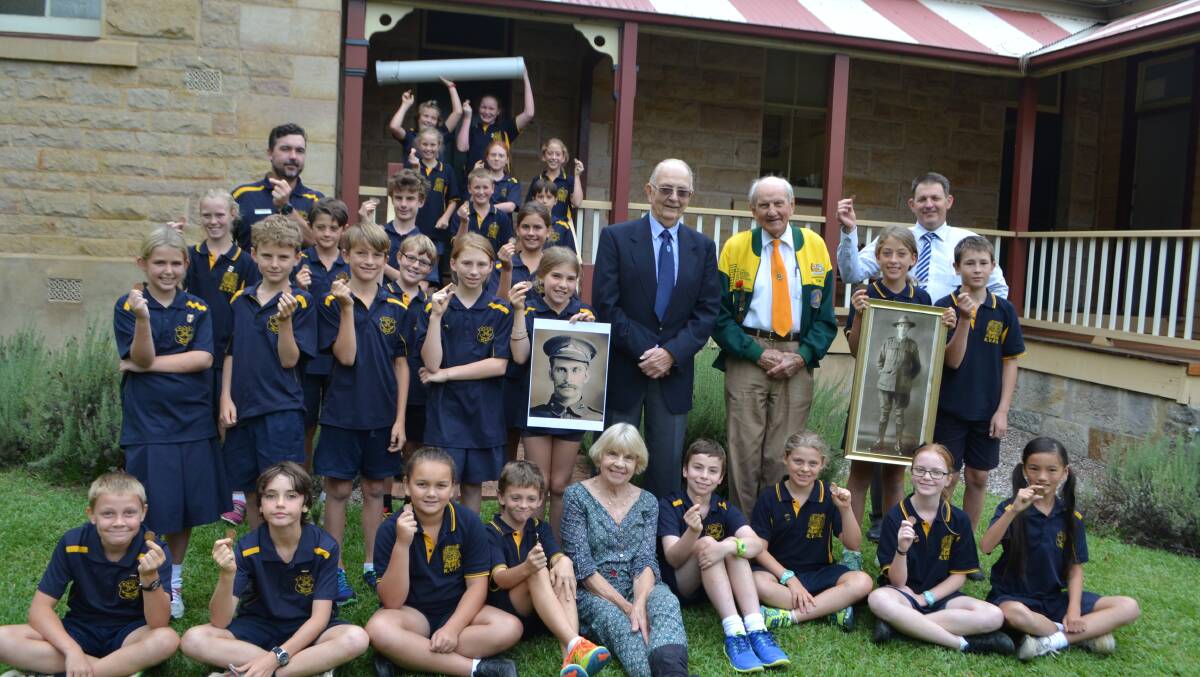 TIME CAPSULE: Kangaroo Valley year 5 and 6 students listen to World War I tales from Slim Ward and Ron Brooks whose ancestors fought overseas. Kangaroo Valley teacher Andrew Smee, principal John Bond and Kangaroo Valley Anzac Committee chairman Joan Bray filled the time capsule with special items from the day’s event to commemorate the centenary of Anzac which will be stored at the Kangaroo Valley Pioneer Museum Park until it is opened again in 2045.