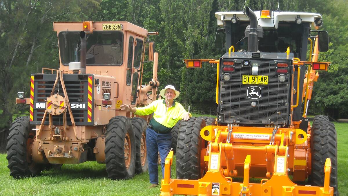 SMOOTH OPERATOR: Colin Condon from Bomaderry with the old Adams grader, left, and the newer John Deere.