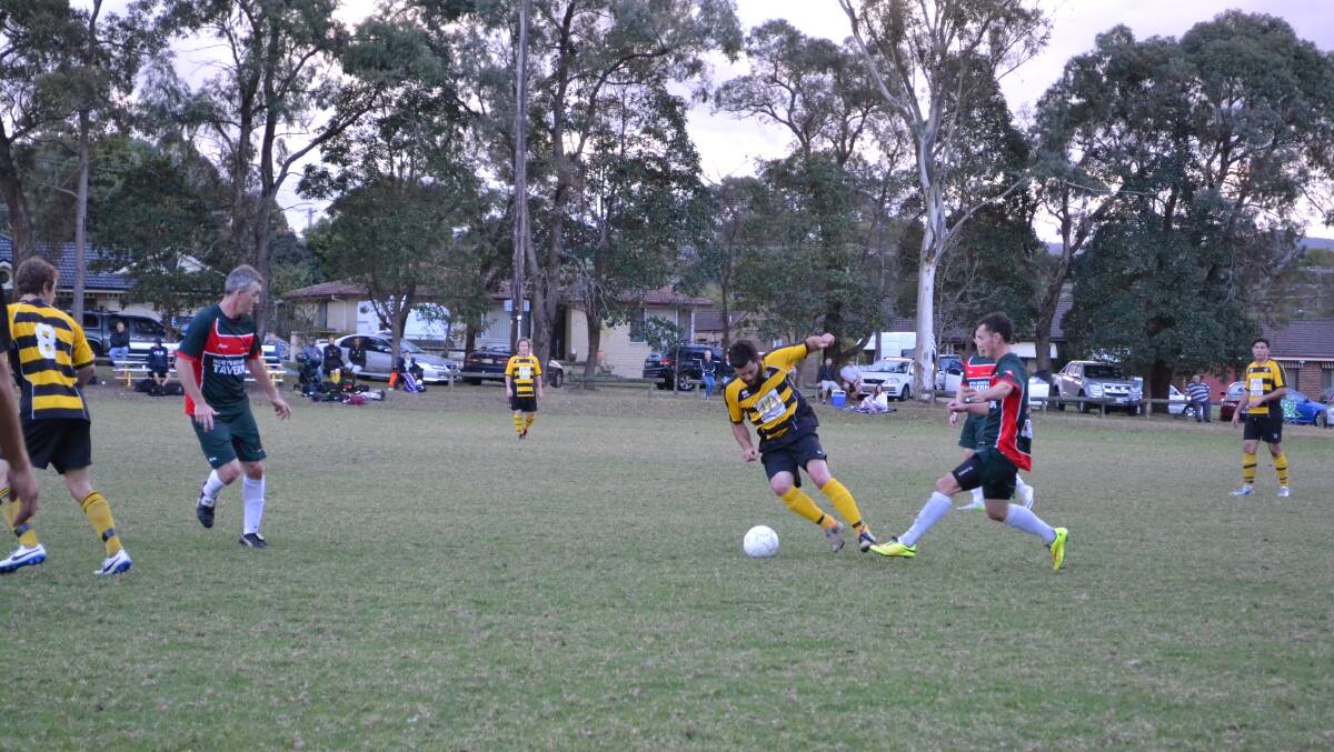 CONTEST: Bomaderry’s Ben Foley and Aaron Crittenden from Illaroo fight for the ball during Saturday’s clash, which Bomaderry won 4-1. Photo: HAYLEY WARDEN  
