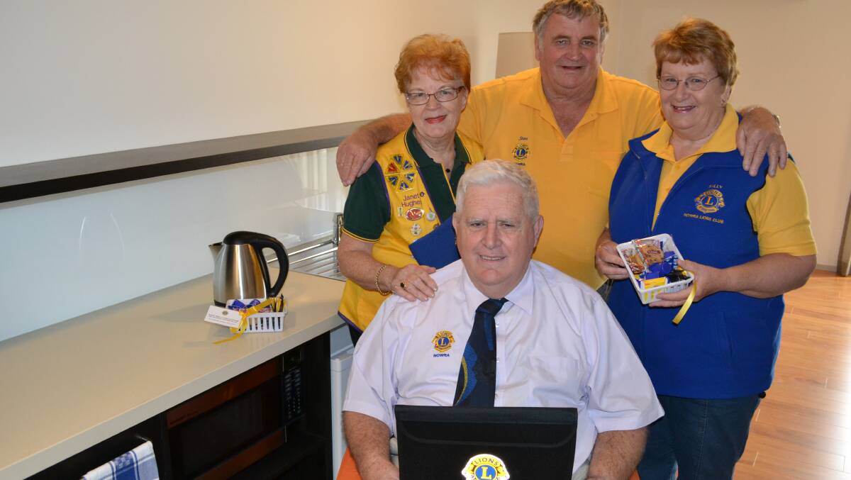 WELCOME: Nowra Lions Club members Janet Hughes, Stan and Sally Wilton with Barrie Hepburn (front) make up welcome packs for guests staying at the Shoalhaven Cancer Care Centre accommodation rooms.